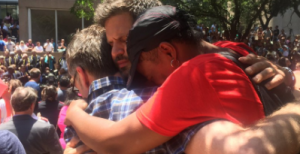 Three strangers hugging